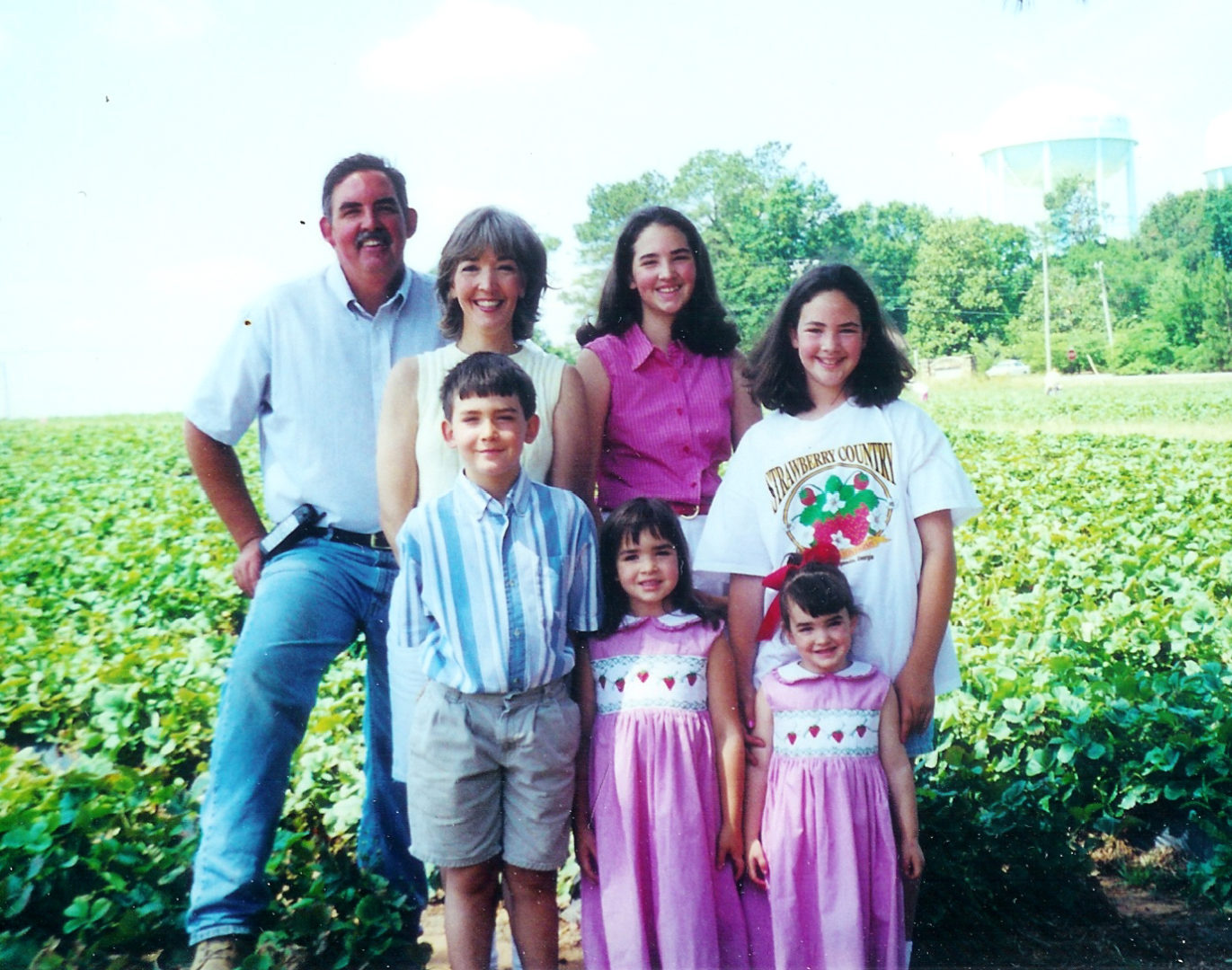Family in strawberry field