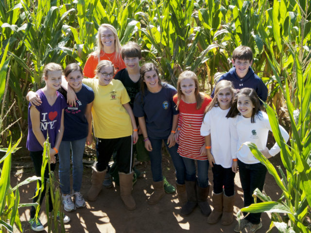 Staff member with group in corn maze